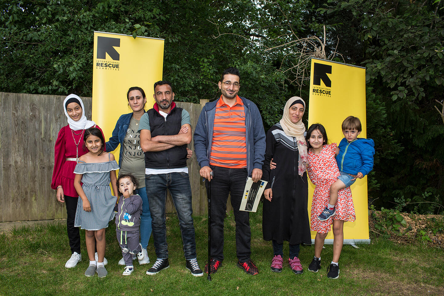 Two families pose together at the first IRC RISE graduation in Horsham, UK.