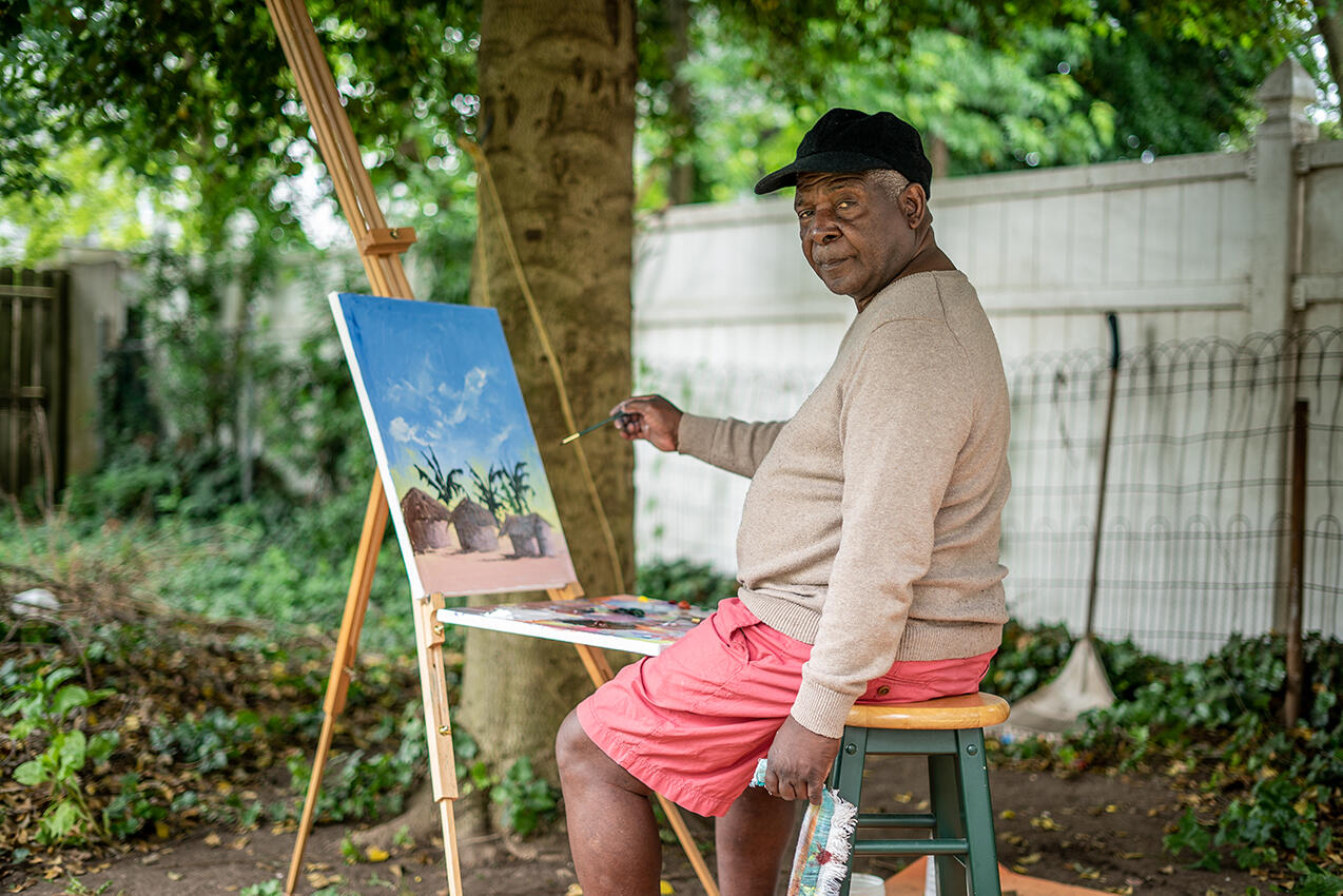 Chishimba painting outside.