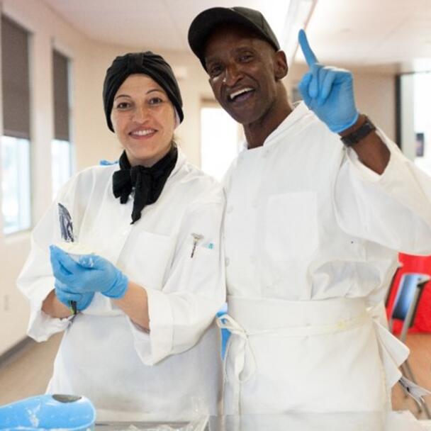 Two chefs making baked goods in job training