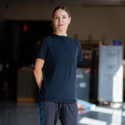 Christive Shevchenko shared her story with the IRC for World Refugee Day 2021. Christive Shevchenko stands in a studio in her rehearsal clothes for a World Refugee Day 2021 photo shoot.