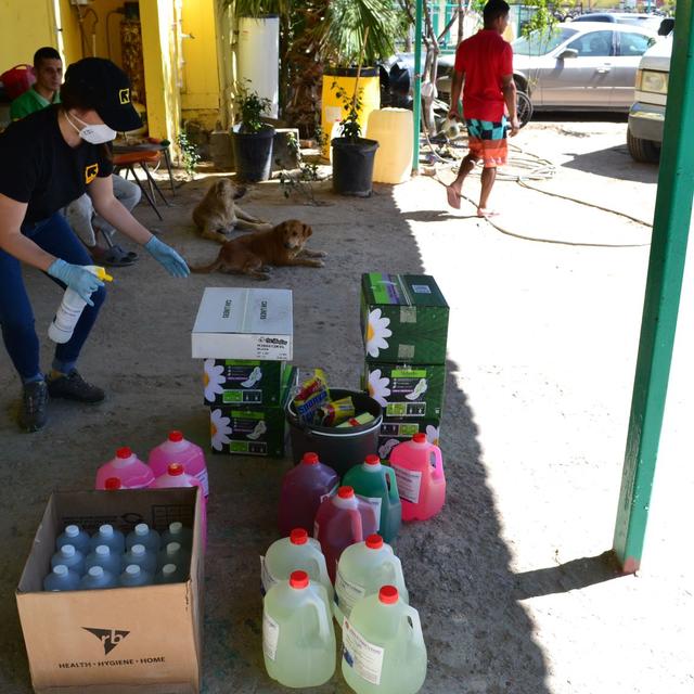 An IRC staff member stands above buckets of cleaning supplies to be delivered to shelters in Ciudad Juárez, Mexico. 