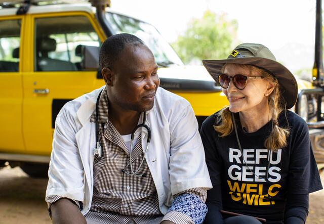 Mia ferrow sits next to an employee of IRC