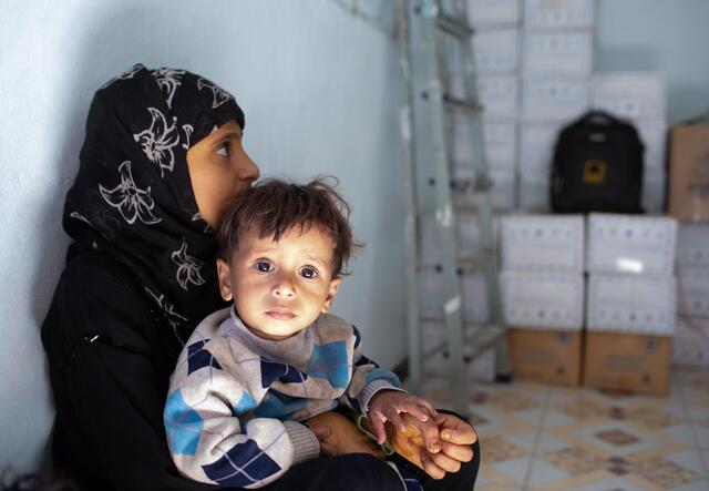 Woman and her child waiting at a storage place