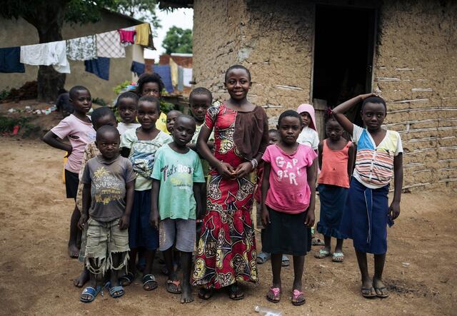 Christelle Muvingulwa in front of a group of children