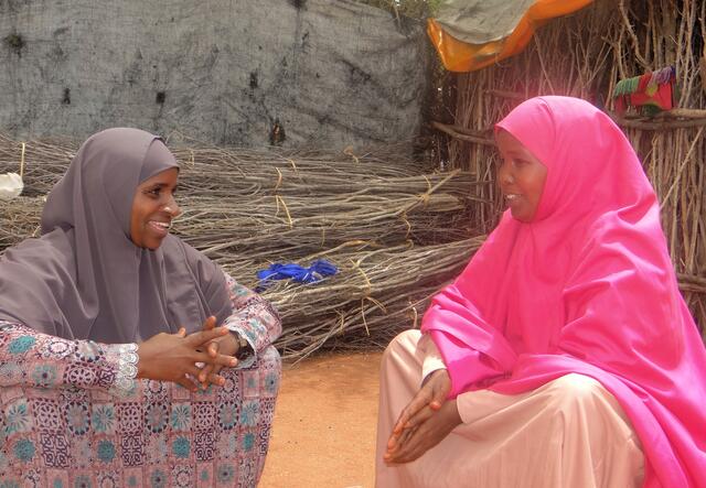 two women sitting and chatting