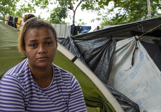 A women in front of a tent