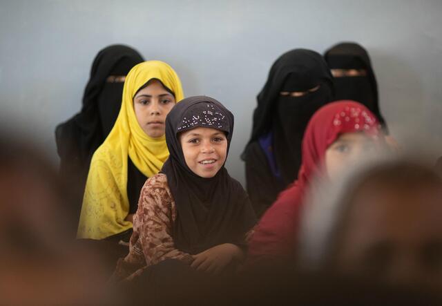 young, veiled girls sitting in rows