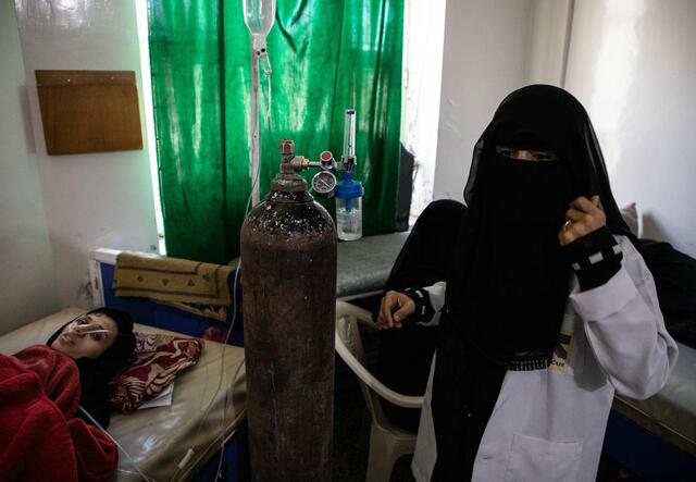 a woman is connected to a oxygen cylinder