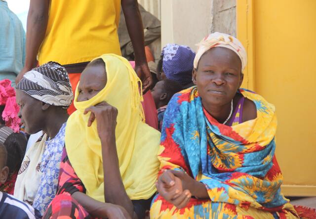 Some women sittning and waiting