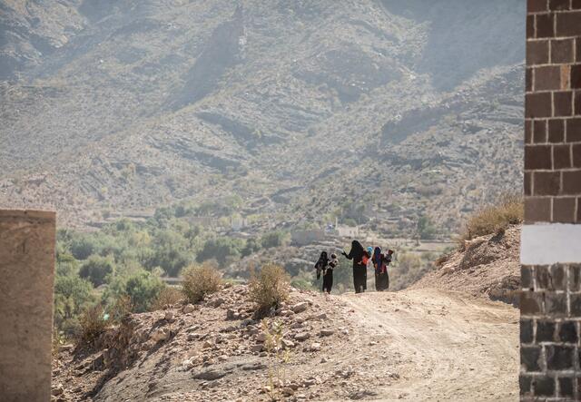 women walking over mountain