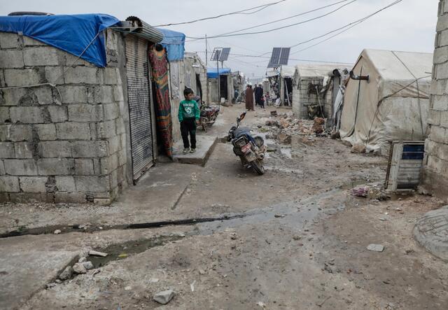 Daily scene on a simple road between tents and barracks