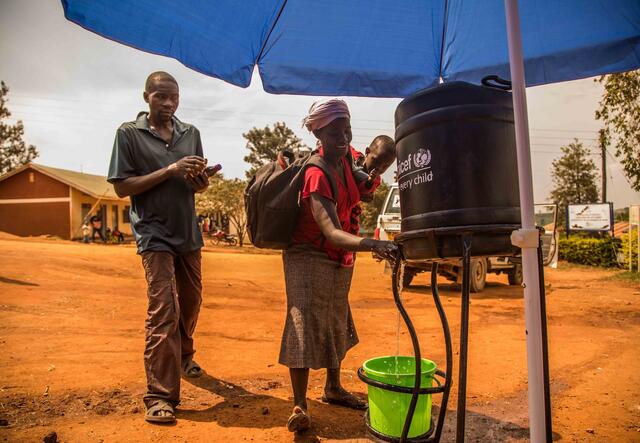 People washing their hands on a mobile washing unit by UNICEF