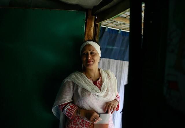 Razia looks on at Rohingya women inside her women’s centre, which she set up to help fight violence and discrimination against women in the camp. 