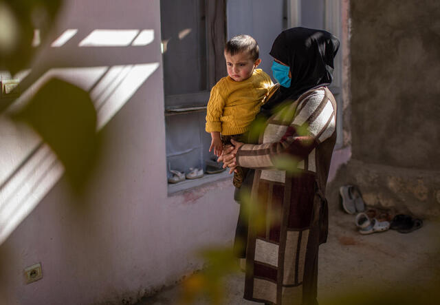 Zulaykha* plays with her son outside the home she is renting in Kabul, Afghanistan