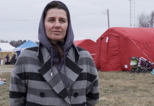 Angelina stands at the border between Ukraine and Poland