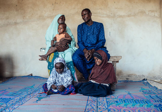 Family portrait of Muhammad Ahmad (husband), 38, Bilikisu Ahmad (Wife), 29, and their children, Aisha, 6 (white & blue patterned Hijab), Fati (Brown Hijab),8 and baby Abba, 3, at their home in Maiduguri, Borno, Nigeria