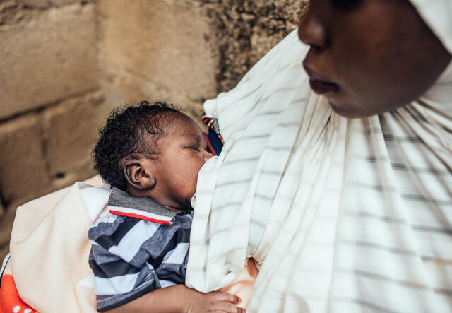 Hussiena Ibrahim Ali, 20, breastfeeds her baby, Bello Ibrahim, 7 days old, few hours after their child naming ceremony at her home in Gwoza, Borno, Nigeria