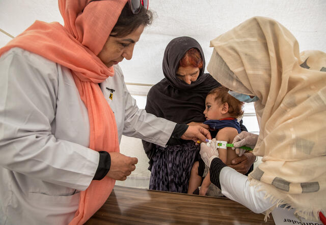 Afghan doctor tending to the sick