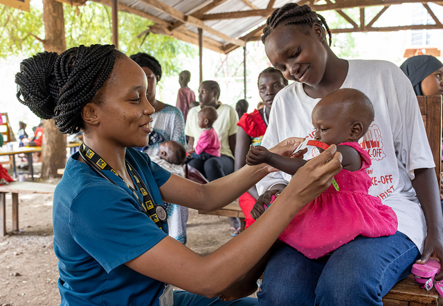 IRC health manager Dr Sila Monthe checks one-year-old Vanessa for malnutrition 