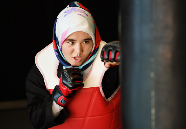 Arifa throws a punch while practicing taekwando