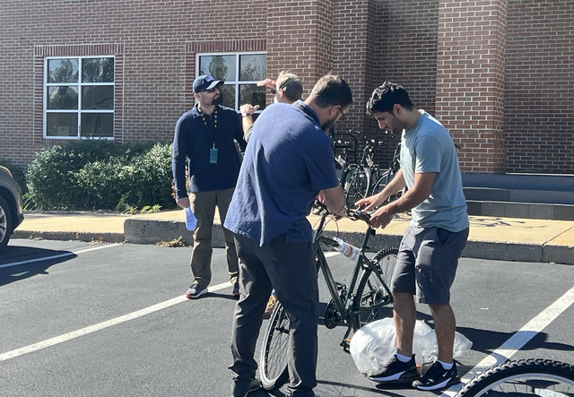 Volunteer working on bike with client