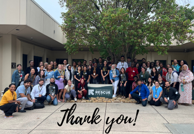 The IRC Atlanta staff taking a group photo outside the office. "Thank you!" graphic text is at the bottom.