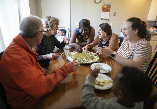 Jacqueline (center) shares a Congolese meal with her friends.