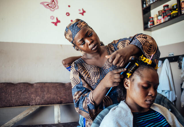 Abigail combs a client's hair in her salon.