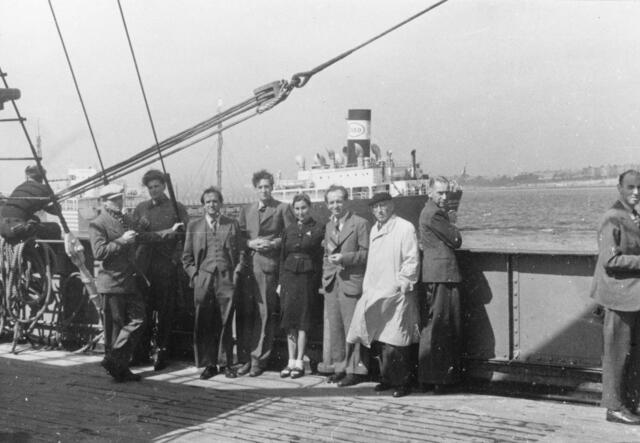 European refugees stand facing the camera, on board converted cargo ship sailing from Marseilles to Martinique, March 25, 1941. 