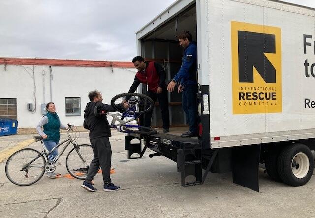 A group of four IRC staff loading bikes onto the IRC box truck