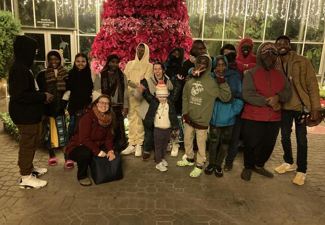 Our Youth Futures team all grouped in front of a red tree.