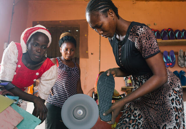 Lydia works on a sandal in the middle of her store, Emmy Quality Shoe Production.