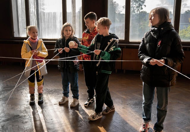 Children participating in rope-based activity at the Safe Healing and Learning Center.