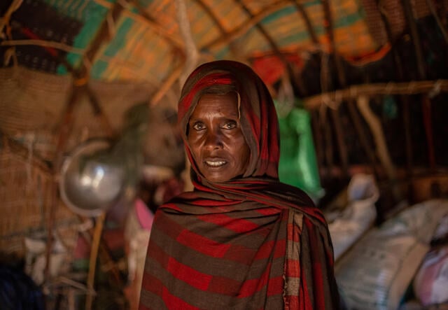 Kessa, 40, stands facing the camera in Elele, Somali region, Ethiopia.