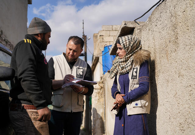 IRC staff talking with man to provide cash assistance.