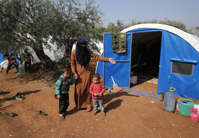 Dania stands with two of her children.