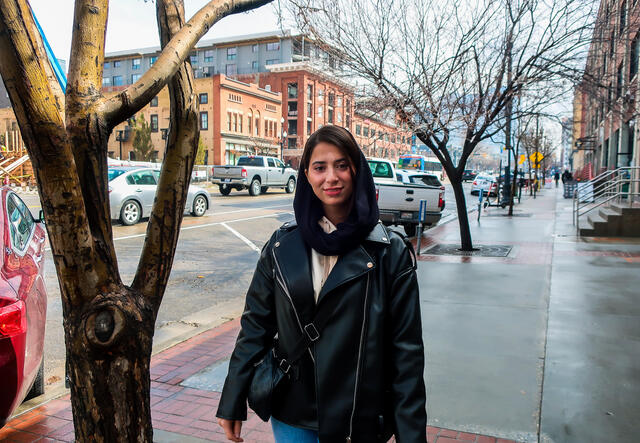 Mahsa stands by a tree outside of the IRC in Salt Lake City.
