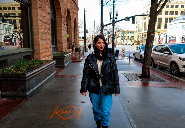 Mahsa walking down the street in Salt Lake City.
