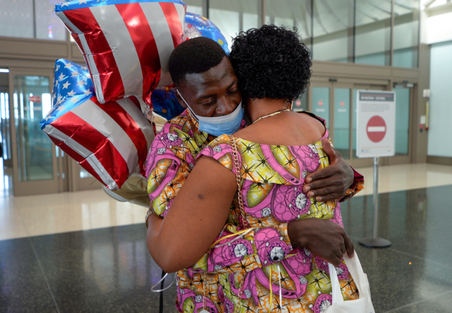 Sifa embraces her husband, Kakule, at the Salt Lake City airport.