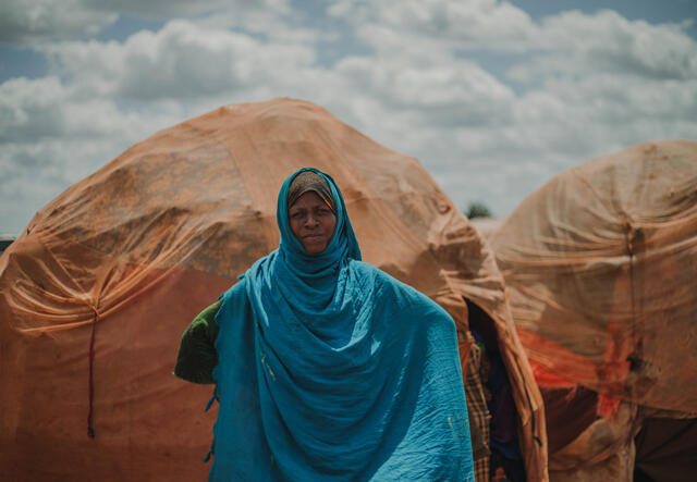 Woman standing in front of a tent