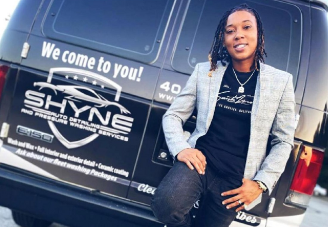 Brittney Cooper standing in front of a Shyne Auto Detail business van.