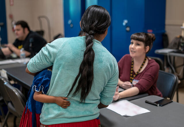 Asylum seeking family checks in at the Welcome Center.