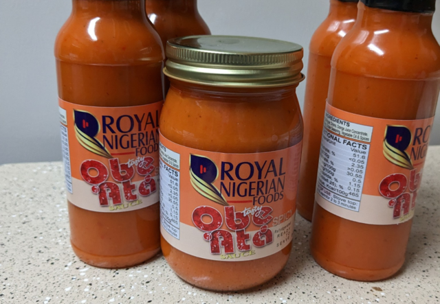 Four bottles and one mason jar of Royal Nigerian Food branded sauce.