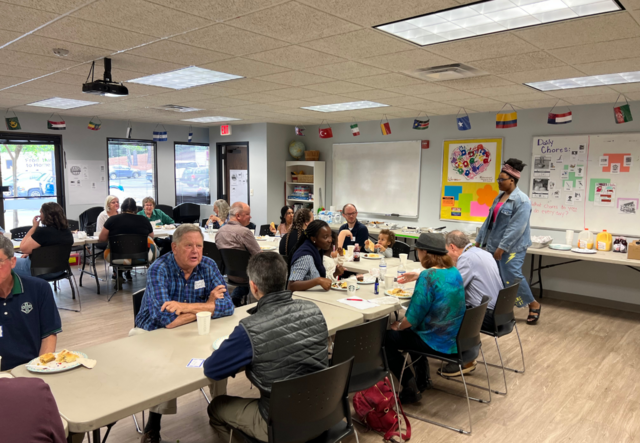 Our volunteers and staff eating lunch in our English classroom.