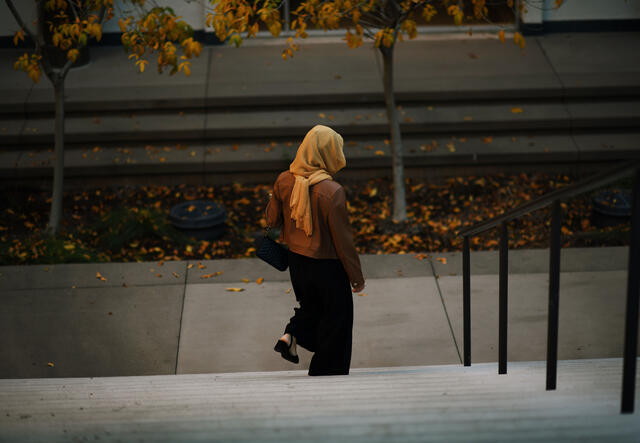 Afghan scholar walks down a set of stairs at ASU.