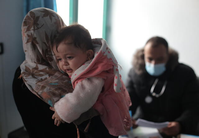 A Syrian Mother and her child waiting to be examined at the IRC center.