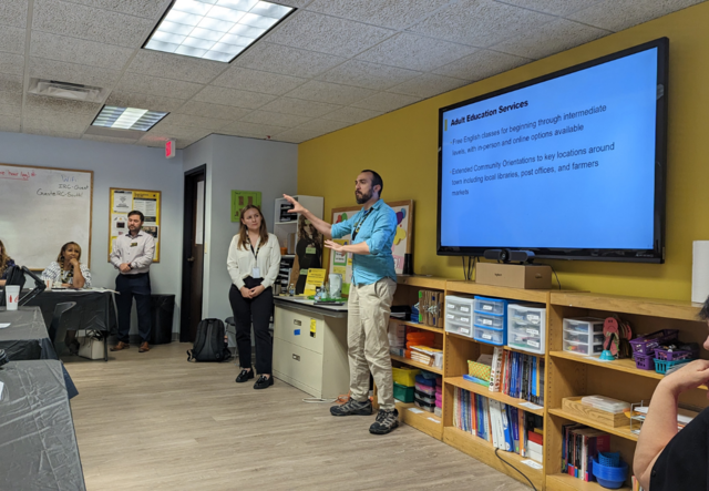 Adult Education Supervisor Chris Carpenter shares information about his program with live Ukrainian interpretation.