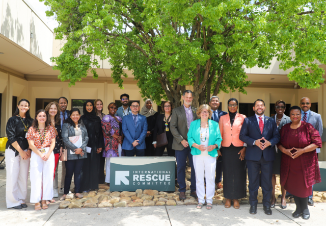A group photo of IRC Atlanta staff and guests outside of the IRC office.
