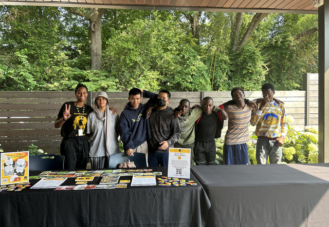 New roots youth food justice interns at their table in the Atlanta Botanical Gardens.
