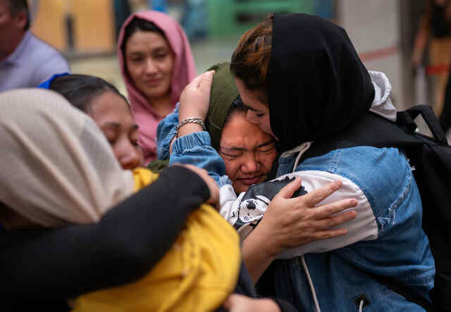 Sitara Hussaini, right, hugs and kisses her mother Sanowbar Sakhi.